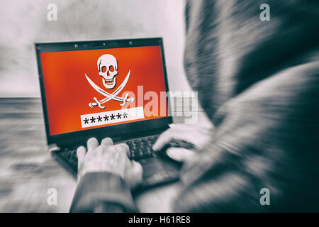Rückansicht eines Hackers tragen einen Hoodie und ein Kennwort auf einem Laptop-Bildschirm zu stehlen Stockfoto