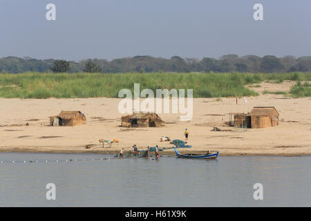 Fischerfamilie ziehen in ihr Netz an den Ufern des Flusses Irrawaddy in Myanmar (Burma). Stockfoto