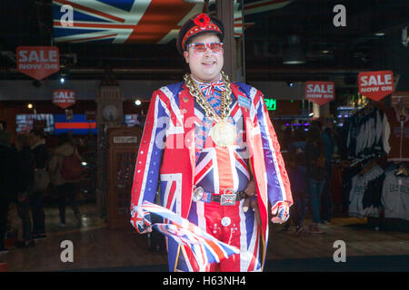 LONDON - 18. Oktober: Verkäufer trägt Uniform symbolisiert englische Flagge am Eingang des Shops Cool Britannia. Im Hintergrund Autolack Stockfoto