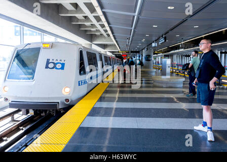 San Francisco, CA, USA, chinesischer Mann allein im leeren Zug BART U-Bahn U-Bahn-Bahnsteig am Flughafen Stockfoto