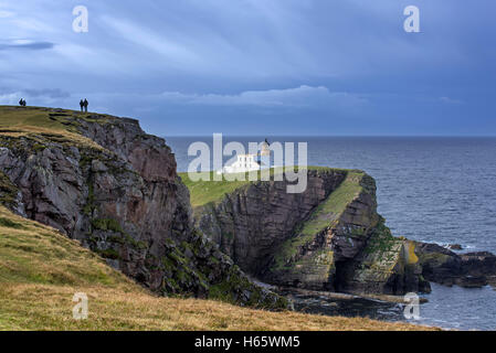 Wanderer und der Stoner Head Leuchtturm am Point of Stoner in Sutherland, Schottisches Hochland, Schottland, Großbritannien Stockfoto