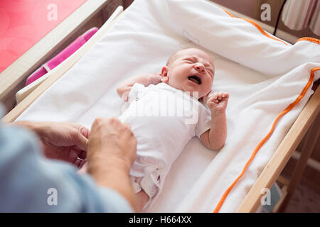 Nicht erkennbare Vater Sohn schreiendes Baby Windel ändern Stockfoto