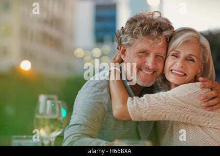 Porträt, Lächeln älteres paar umarmt in städtischen Straßencafé Stockfoto