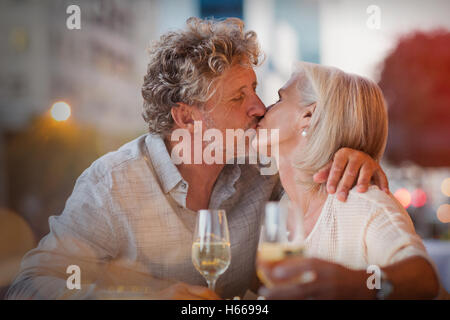 Liebevolle älteres Paar küssen, trinken Weißwein im Straßencafé Stockfoto