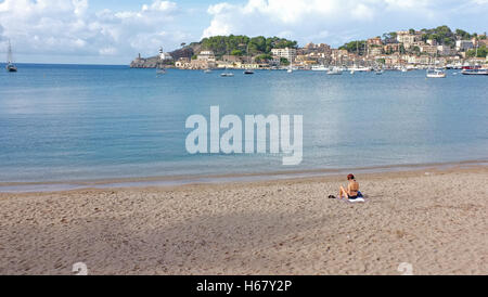 Eine Frau sonnt sich auf einem einsamen Strand in Soller, Mallorca Stockfoto