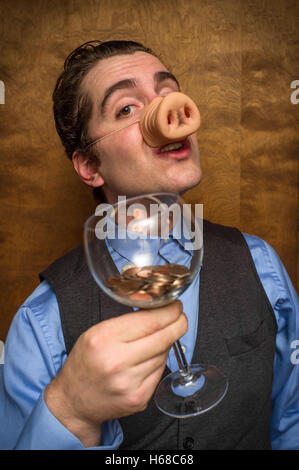 Dumme Schwein-Mann Essen verlieren Änderung für banking-Gier-Bild Stockfoto