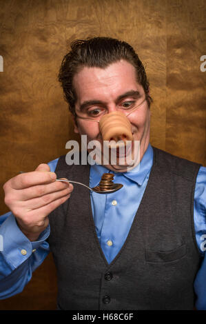 Dumme Schwein-Mann Essen verlieren Änderung für banking-Gier-Bild Stockfoto