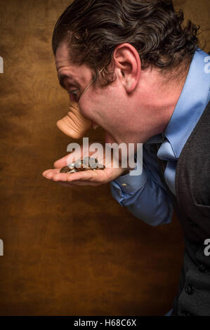 Dumme Schwein-Mann Essen verlieren Änderung für banking-Gier-Bild Stockfoto