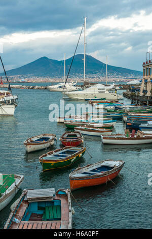 Die Bucht von Neapel mit bunten Fischerbooten und dem Vesuv im Hintergrund. Stockfoto