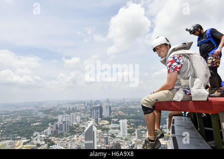 Kuala Lumpur, KUALA LUMPUR, MALAYSIA. 3. Oktober 2016. Base-Jumper, Beau Riebe(25, USA) sitzen an den 300 m hohen Skydeck von Malaysias Wahrzeichen Kuala Lumpur Tower vor dem Hintergrund der Skyline der Stadt am 3. Oktober 2016 während der internationalen KL Tower spezifische Veranstaltung. © Chris Jung/ZUMA Draht/Alamy Live-Nachrichten Stockfoto