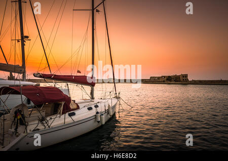 Boote in alten venezianischen Hafen von Chania bei Sonnenuntergang. Blick auf den alten venezianischen Hafen von Chania auf Kreta, Griechenland. Stockfoto