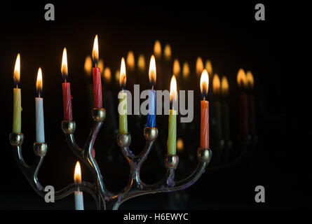 Menorah mit allen Kerzen angezündet und Reflexionen im Glasfenster in der letzten Nacht Chanukka Stockfoto