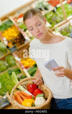 Frau, die Überprüfung ihrer Einkaufsliste Stockfoto