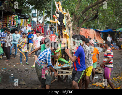 Gruppe von Männern tragen Durga Idol zum Fluss Ganges eintauchen in Babughat Kolkata, Westbengalen, Indien. Stockfoto