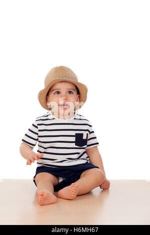 Neun Monate altes Baby mit Matrosen-Look auf dem Boden sitzend Stockfoto