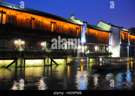 Die beleuchteten Gebäuden entlang der Wasserkanäle in Tongxiang Wuzhen malerischen Westblick auf die Stadt in der Provinz Zhejiang China in der Nacht. Stockfoto