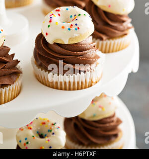 Muffins mit Schokolade Zuckerguss und kleine donuts Stockfoto