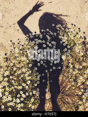 Frau Schatten am Strand in Blumen Stockfoto