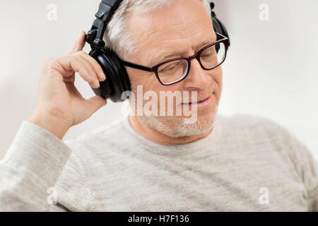 glücklicher Mann Kopfhörer anhören von Musik zu Hause Stockfoto