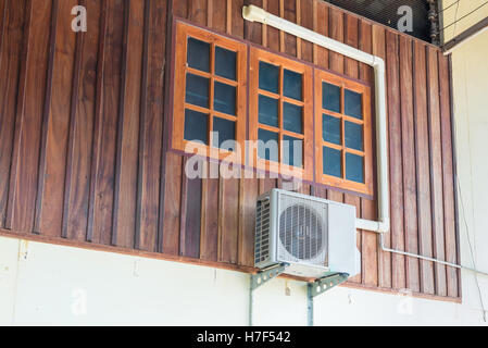 Eine Klimaanlage installiert außerhalb des Hauses auf Holzwand Stockfoto