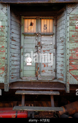 Holzstruktur mit Malerei Farbe abgeblättert auf einem alten Wagen Wand Stockfoto