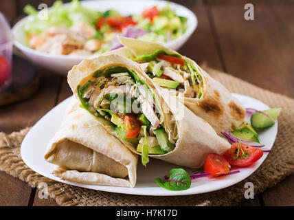 Frische Tortilla wraps mit Huhn und frischem Gemüse auf Platte Stockfoto