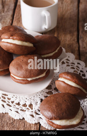 Amerikanische Dessert Schokolade Whoopie Pie und Kaffee close-up auf dem Tisch. vertikale Stockfoto