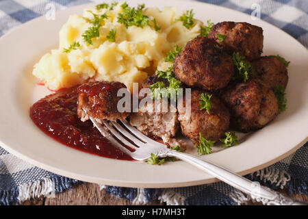 Schwedische Fleischbällchen Kottbullar, Preiselbeer-Sauce mit Beilage Kartoffelpüree auf der Platte Nahaufnahme. horizontale Stockfoto