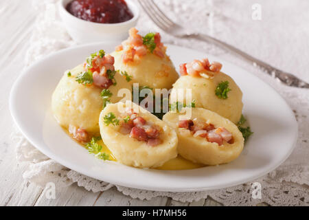 Kartoffelknödel mit Speck, Butter und Petersilie Nahaufnahme auf einer Platte. horizontale Stockfoto