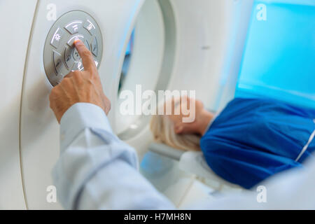 Arzt, die Vorbereitung eines Patienten auf dem Scanner-Zimmer Stockfoto