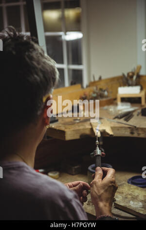 Handwerkerin Lötlampe halten Stockfoto