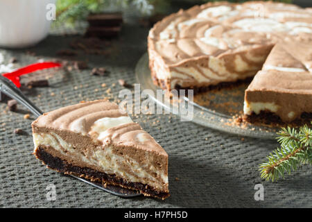 Schokolade Eis Kuchen Zebra auf dunklem Stein. Weihnachtsbaum und Dekoration. Stockfoto