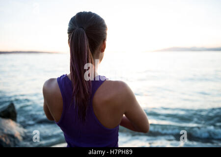 Rückansicht der Frau, die Durchführung von Yoga am Strand Stockfoto