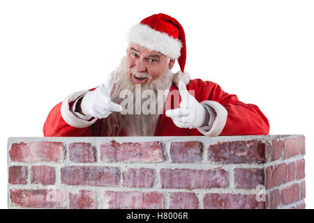 Porträt von happy Santa Claus die Handbewegung über die Mauer Stockfoto