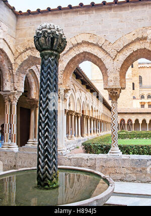 Der schwarze Zick-Zack-geschnitzte Spalte der alten arabischen Brunnen in Monreale Klostergarten, Sizilien, Italien Stockfoto