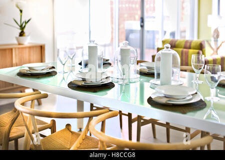 Luxuriöse Tischdekoration in einem Haus, einschließlich Glas Wein leeren Teller und Servietten, Frühstück oder Mittagessen, Stühle sind komfortabel Stockfoto