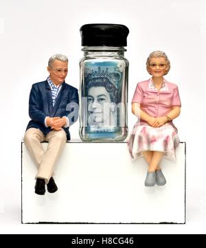 Ein Rentner Figur paar sitzt mit dem Queens-Kopf auf eine fünf-Pfund-Note in einem kleinen Glas Stockfoto