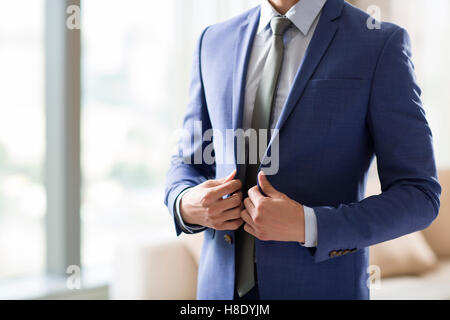 Junge chinesische Geschäftsmann Ankleiden am Morgen Stockfoto