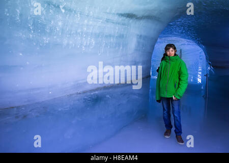 Kind besucht Ice cave Tunnel in Schweizer Alpen-Gletscher. Schulkind im Ice-Tunnel in den Bergen wandern. Stockfoto