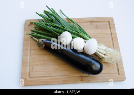 Aubergine mit Frühlingszwiebeln auf Schneidebrett Stockfoto
