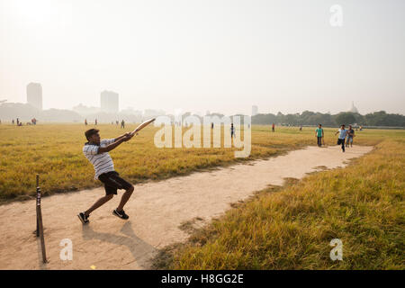 Junge Männer spielen Cricket auf dem Maidan in Kolkata (Kalkutta), Indien Stockfoto