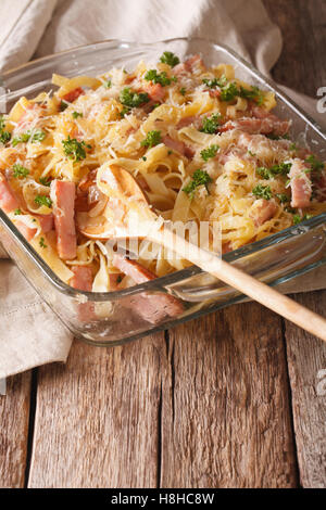 Österreichische Küche: Nudeln überbacken mit Schinken und Käse-close-up auf dem Tisch. vertikale Stockfoto