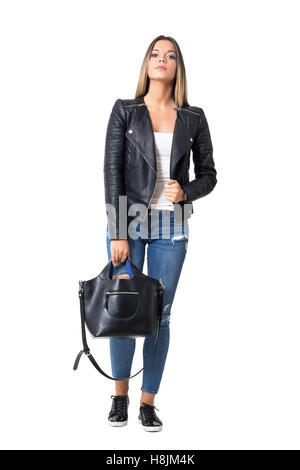 Wunderschöne stilvolle lässige Frau in Jeans und Lederjacke, schwarze Handtasche halten. Ganzkörper-Länge-Porträt isoliert Stockfoto