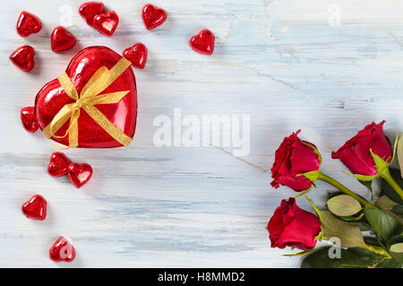 Rote Rosen und Herzen geformt Pralinen. Stockfoto