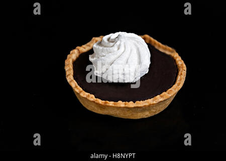 Schokoladen-Kuchen mit Baiser-Törtchen auf schwarzem Hintergrund isoliert Nahaufnahme. Stockfoto