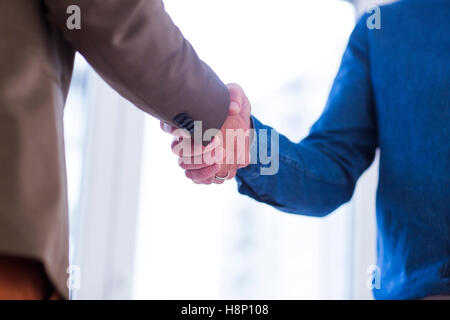 Mann und Frau Händeschütteln im Büro Stockfoto