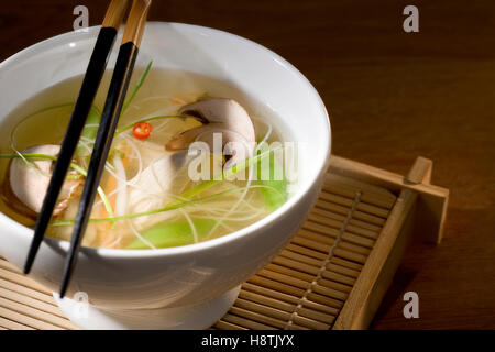 Hühnersuppe mit Gemüse in Schüssel mit Chop-sticks Stockfoto