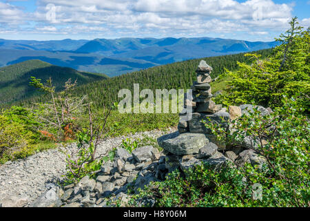 Cairn Kennzeichnung eine Spur in den Bergen, Wald im Hintergrund Stockfoto