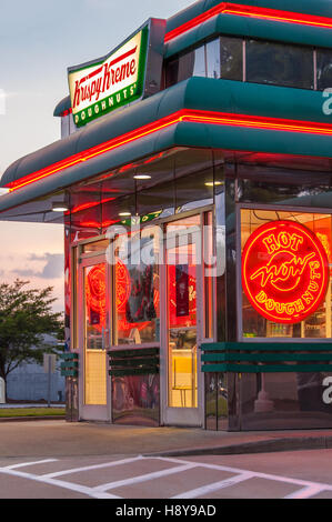 Krispy Kreme Doughnuts Shop erstrahlt in der Abenddämmerung in der Nähe von Atlanta, Georgia, USA. Stockfoto