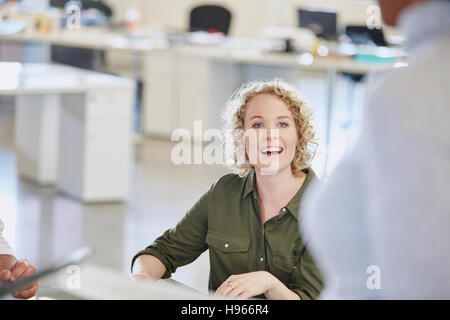 Lächelnde Geschäftsfrau hören in treffen Stockfoto